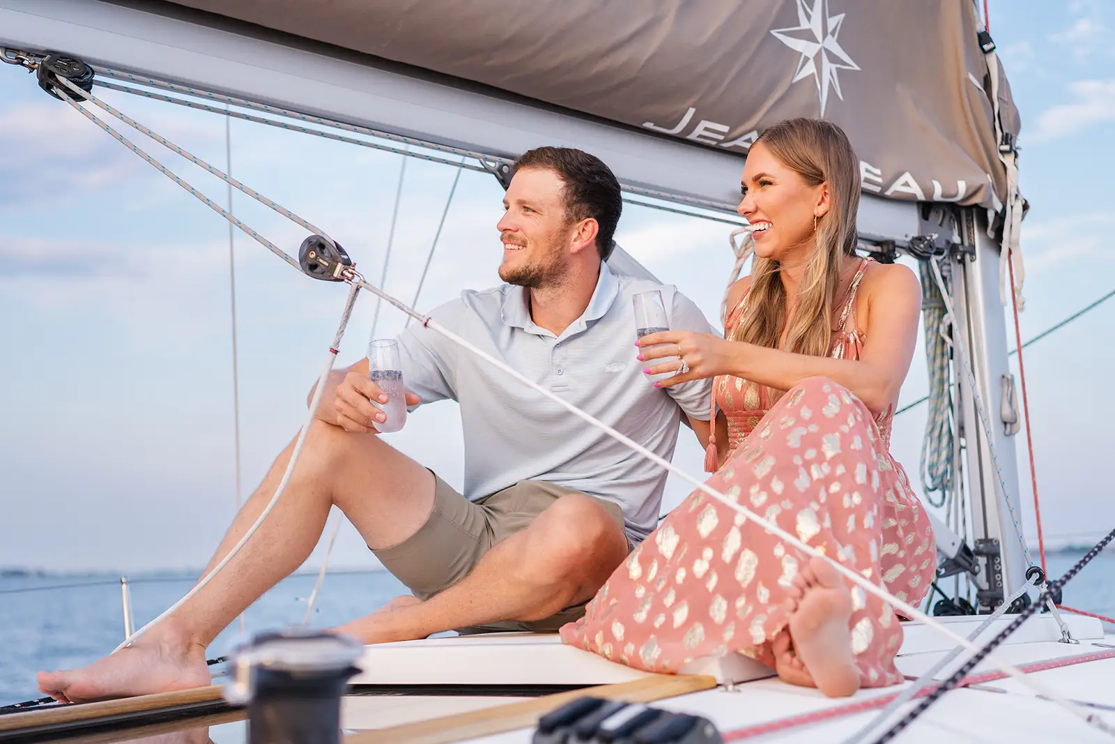 Couple relaxing on the deck of Esprit de Joy during a private daytime charter